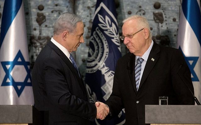 Prime Minister Benjamin Netanyahu (L) shakes hands with Israeli President Reuven Rivlin as he is formally given the task to form the next government, at the president's residence in Jerusalem on March 25, 2015. (photo credit: AFP PHOTO / MENAHEM KAHANA) Prime Minister Benjamin Netanyahu (L) shakes hands with Israeli President Reuven Rivlin as he is formally given the task to form the next government, at the president's residence in Jerusalem on March 25, 2015. (photo credit: AFP PHOTO / MENAHEM KAHANA)