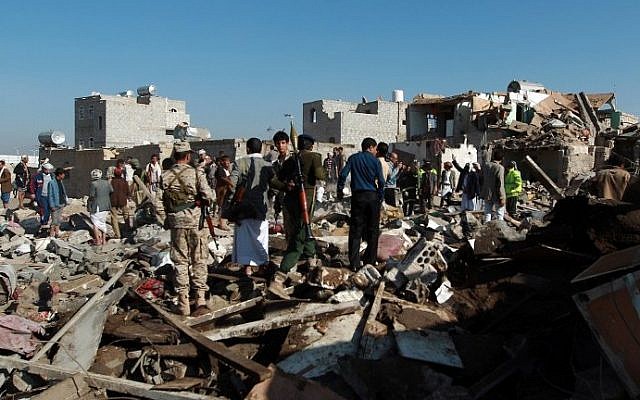 Yemeni Houthi rebels and members of the security forces loyal to the Shiite movement inspect the damage at the scene of a Saudi airstrike targeting the group, which controls Sanaa near the airport in the Yemeni capital, on March 26, 2015. (photo credit: Mohammed Huwais/AFP) Yemeni Houthi rebels and members of the security forces loyal to the Shiite movement inspect the damage at the scene of a Saudi airstrike targeting the group, which controls Sanaa near the airport in the Yemeni capital, on March 26, 2015. (photo credit: Mohammed Huwais/AFP)