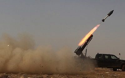 Iraqi government forces fire a locally made rocket from a position on the southern outskirts of Tikrit, on March 30, 2015, during a military operation to retake the city from Islamic State (IS) group jihadists. (photo credit: AFP/AHMAD AL-RUBAYE) 