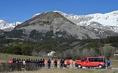 Rescue workers and Red Cross members pay tribute at a memorial for the victims of the Germanwings plane crash in Le Vernet on March 27, 2015. The Germanwings co-pilot who crashed his Airbus into the French Alps, killing all 150 aboard, hid a serious illness from the airline, prosecutors said amid reports he was severely depressed. (photo credit: AFP / BORIS HORVAT)