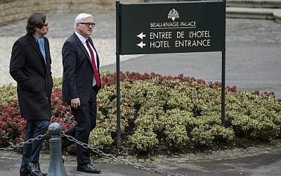 German Foreign Minister Frank-Walter Steinmeier (R) leaves the Beau-Rivage Palace hotel during a break in Iran nuclear talks in Lausanne on March 29, 2015. (photo credit: AFP PHOTO / FABRICE COFFRINI)