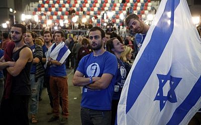 Israeli supporters of the Zionist Union party react to exit poll figures outside the party's headquarters on March 17, 2015 in the city of Tel Aviv. (photo credit: AFP/THOMAS COEX)