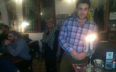 Jerusalem deputy mayor Ofer Berkovitch lights Hanukkah candles at Tmol Shilshom, December 2014. (Courtesy)