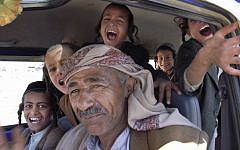 In this photo taken on April 8, 2009, Jewish Yemeni boys sit behind the driver of a minibus as they travel back to the town of Raydah, after a morning of Hebrew classes in the nearby village of Kharif, Yemen photo credit: AP/Hamza Hendawi