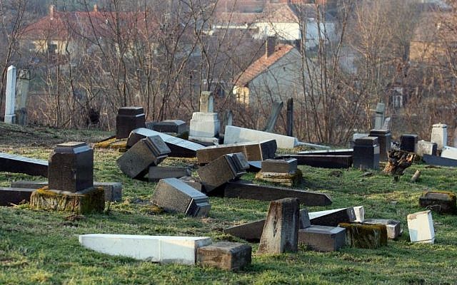 Gravestones lie turned over in the Jewish cemetery in Marcali, 177 kms southwest of Budapest, Hungary, Friday, Jan. 28, 2011 after 75 graves have been violated. (Photo credit: AP/MTI, Gyoergy Varga)