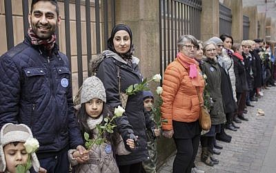 Danish people of Muslim, Jewish and Christian faith form a peace ring around the synagogue in Copenhagen, Saturday, March 14, 2015. (AP Photo/Mads Nissen/Polfoto)