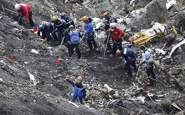 Rescue workers work on debris of the Germanwings jet at the crash site near Seyne-les-Alpes, France, March 26, 2015. (photo credit: AP/Laurent Cipriani) Rescue workers work on debris of the Germanwings jet at the crash site near Seyne-les-Alpes, France, March 26, 2015. (photo credit: AP/Laurent Cipriani)