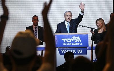 Prime Minister Benjamin Netanyahu greets supporters and hails victory at the Likud party's election headquarters in Tel Aviv, Tuesday, March 17, 2015. (AP Photo/Oded Balilty)