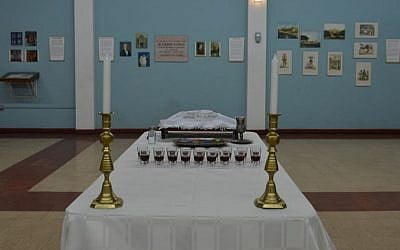 A table holding glasses of kosher wine and bread in the cultural heritage center of Jamaica's last synagogue, the Sha’are Shalom, in Kingston on Feb. 27, 2015. Community leader Ainsley Henriques says the Kingston synagogue evolved out of Sephardic conservative traditions from the Iberian peninsula but adopted liberal practices from British and American Reform movements. (Photo credit: David McFadden/AP Photo)