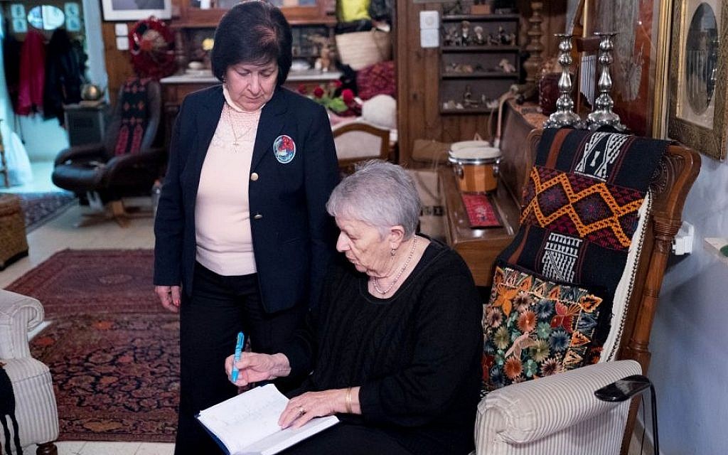 Najla and Yael log sales in Yael's sitting room in Jerusalem (photo credit: Shaina Shealy/Times of Israel) Najla and Yael log sales in Yael's sitting room in Jerusalem (photo credit: Shaina Shealy/Times of Israel)