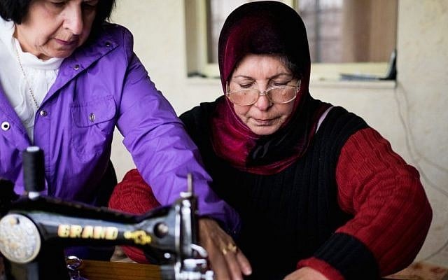 Najla shows Om Ahmed how to sew zippers onto pouches photo credit: Shaina Shealy/Times of Israel Najla shows Om Ahmed how to sew zippers onto pouches photo credit: Shaina Shealy/Times of Israel