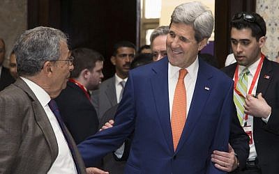 US Secretary of State John Kerry, center, greets audience members before speaking to a meeting of the American Chamber of Commerce in Egypt in Sharm el-Sheikh Friday, March 13, 2015. (photo credit: AP/Brian Snyder, Pool) 