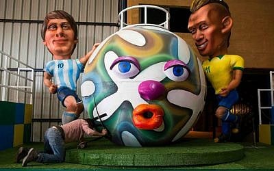 Getting ready for Holon's 2015 Adloyada parade with a float depicting Argentine soccer player Lionel Messi (L) and Brazilian player Neymar (R) at a set design factory near Kfar Saba (photo credit: Yonatan Sindel/Flash 90)