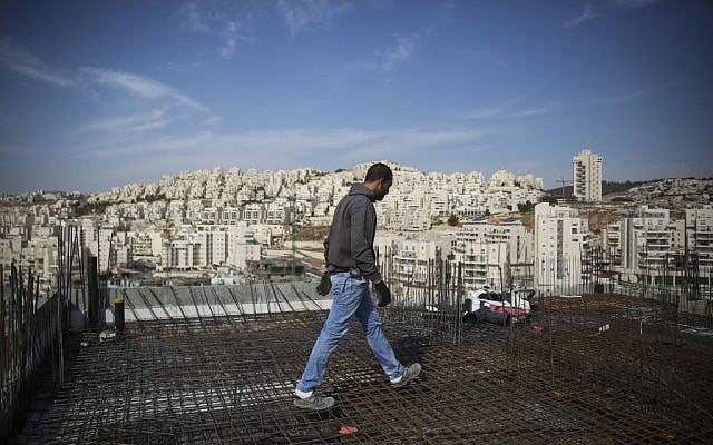 A construction worker next to the East Jerusalem neighborhood of Har Homa in October, 2014. (Hadas Parush/Flash90) A construction worker next to the East Jerusalem neighborhood of Har Homa in October, 2014. (Hadas Parush/Flash90)