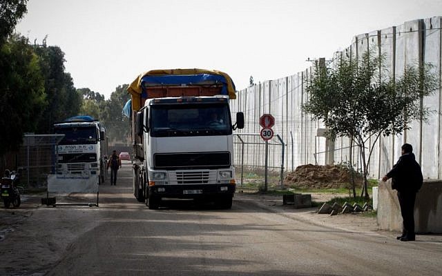A Palestinian policeman stands near trucks loaded with cement that entered the Gaza Strip from Israel through the Kerem Shalom crossing in Rafah in the southern Gaza Strip on November 25, 2014. (Photo credit: Abed Rahim Khatib / Flash90) A Palestinian policeman stands near trucks loaded with cement that entered the Gaza Strip from Israel through the Kerem Shalom crossing in Rafah in the southern Gaza Strip on November 25, 2014. (Photo credit: Abed Rahim Khatib / Flash90)