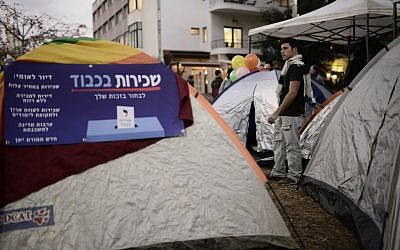 Israeli social activists seen near tents on Rothschild Boulevard in Tel Aviv on March 1, 2015. Israeli social activists pitched tents in Tel Aviv Rothschild Boulevard on Sunday, protesting against the high cost of living and housing. (Photo by Tomer Neuberg/Flash90)