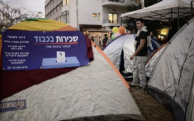 Israeli social activists seen near tents on Rothschild Boulevard in Tel Aviv on March 1, 2015. Israeli social activists pitched tents in Tel Aviv Rothschild Boulevard on Sunday, protesting against the high cost of living and housing. (Photo by Tomer Neuberg/Flash90) Israeli social activists seen near tents on Rothschild Boulevard in Tel Aviv on March 1, 2015. Israeli social activists pitched tents in Tel Aviv Rothschild Boulevard on Sunday, protesting against the high cost of living and housing. (Photo by Tomer Neuberg/Flash90)