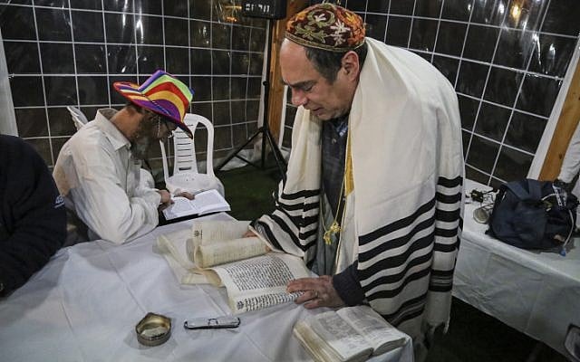 Jews take part in the reading of the Megillat Esther on the eve of the Jewish Purim holiday, at the Oz VeGaon outpost in Gush Etzion. March 4, 2015. (photo credit: Gershon Elinson/Flash90) Jews take part in the reading of the Megillat Esther on the eve of the Jewish Purim holiday, at the Oz VeGaon outpost in Gush Etzion. March 4, 2015. (photo credit: Gershon Elinson/Flash90)