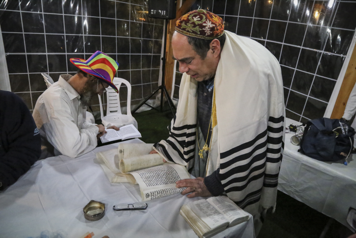 Jews take part in the reading of the Megillat Esther on the eve of the Jewish Purim holiday, at the Oz VeGaon outpost in Gush Etzion. March 4, 2015. (photo credit: Gershon Elinson/Flash90) Jews take part in the reading of the Megillat Esther on the eve of the Jewish Purim holiday, at the Oz VeGaon outpost in Gush Etzion. March 4, 2015. (photo credit: Gershon Elinson/Flash90)