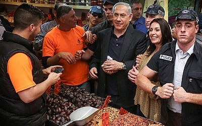 Prime Minister and head of the Likud party Benjamin Netanyahu seen with Likud member Miri Regev during a visit at the Jerusalem Mahane Yehuda market on March 9, 2015. (photo credit: Flash90) Prime Minister and head of the Likud party Benjamin Netanyahu seen with Likud member Miri Regev during a visit at the Jerusalem Mahane Yehuda market on March 9, 2015. (photo credit: Flash90)