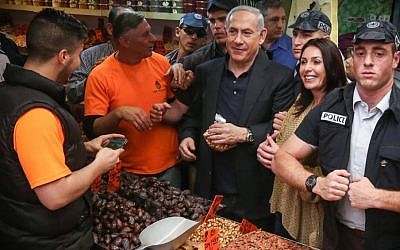Prime Minister and head of the Likud party Benjamin Netanyahu (C) seen with MK Miri Regev (2nd R) during a visit to Jerusalems Mahane Yehuda market, March 9, 2015. (photo credit: Flash90) 