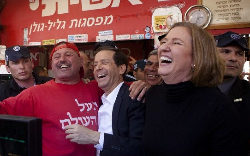 Zionist Union leaders Isaac Herzog (center) and Tzipi Livni (right) during a campaign tour at the Carmel Market in Tel Aviv, March 12, 2015 (photo credit: Amir Levy/Flash90)