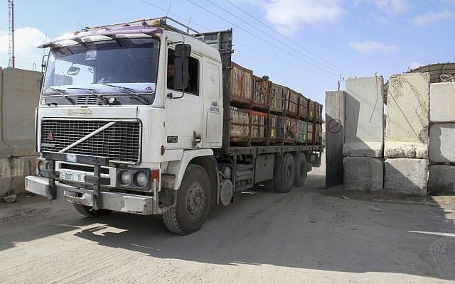A Palestinian trucks loaded with goods entering the Gaza Strip from Israel through the Kerem Shalom crossing in Rafah in southern Gaza Strip, March 15, 2015 (photo credit: Abed Rahim Khatib/Flash90)