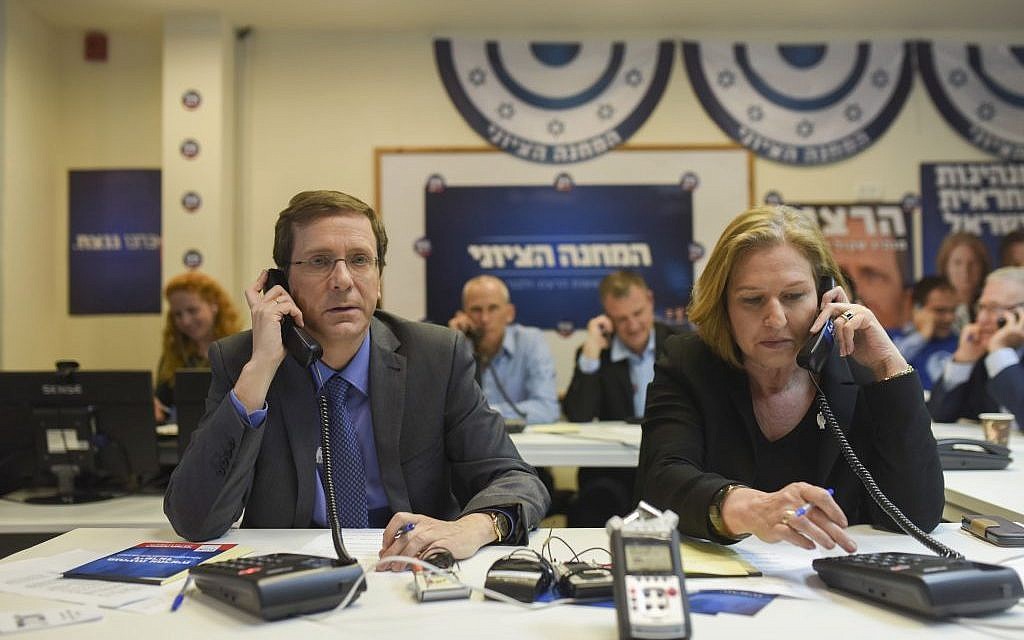 Zionist Union list leaders Isaac Herzog and Tzipi Livni talk to potential voters ahead of the election, at the party headquarters in Tel Aviv, on March 15, 2015 (photo credit: Ben Kelmer/Flash90)