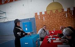 An Israeli Arab woman casts her vote at a polling station in the Arab neighborhood of Beit Safafa, in Jerusalem on Tuesday, March 17, 2015 (photo credit: Miriam Alster/FLASH90)
