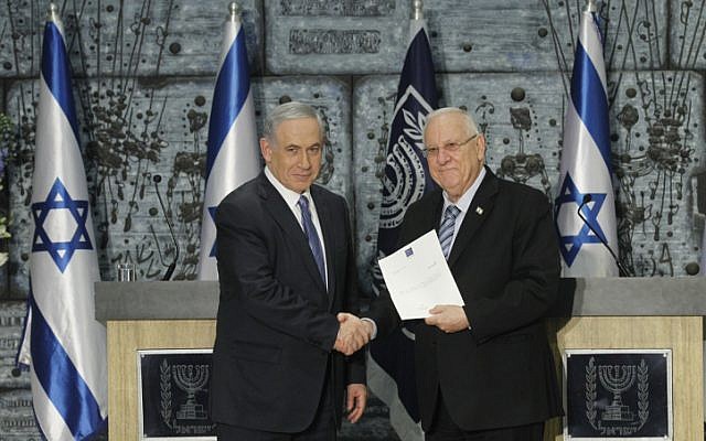 Prime Minister Benjamin Netanyahu (L) shakes hands with Israeli President Reuven Rivlin as he is formally given the task to form the next government, at the president's residence in Jerusalem on March 25, 2015. (photo credit: AFP PHOTO / MENAHEM KAHANA) Prime Minister Benjamin Netanyahu (L) shakes hands with Israeli President Reuven Rivlin as he is formally given the task to form the next government, at the president's residence in Jerusalem on March 25, 2015. (photo credit: AFP PHOTO / MENAHEM KAHANA)