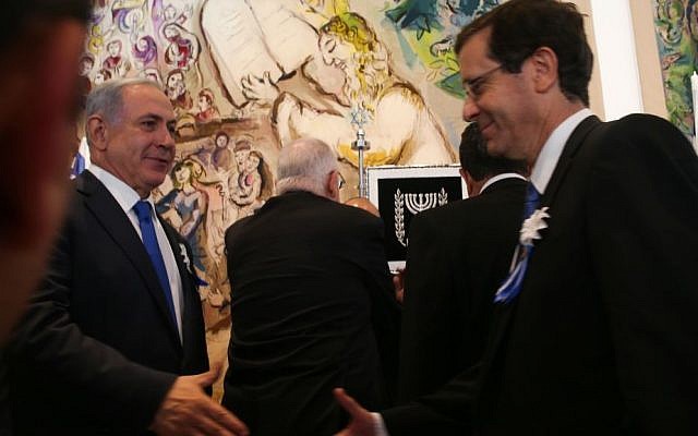 Prime Minister Benjamin Netanyahu shakes hands with Zionist Union leader Isaac Herzog during the opening session of the Knesset on March 31, 2015. (Nati Shohat/Flash90) Prime Minister Benjamin Netanyahu shakes hands with Zionist Union leader Isaac Herzog during the opening session of the Knesset on March 31, 2015. (Nati Shohat/Flash90)