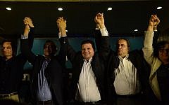 Ayman Odeh (center), head of Israel's Joint (Arab) List, reacts at party headquarters in the northern Israeli town of Nazareth as exit polls in the general elections are announced, March 17, 2015 (photo credit: Basel Awidat/Flash90)