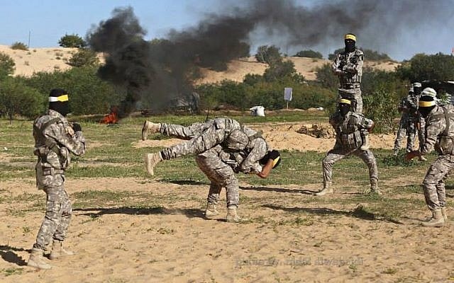 Masked Fatah operatives practice military skills during a drill in Gaza, March 6, 2015 (photo credit: Facebook image) Masked Fatah operatives practice military skills during a drill in Gaza, March 6, 2015 (photo credit: Facebook image)