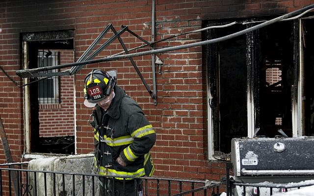 An FDNY firefighter looks over the scene of a house fire on Saturday, March 21, 2015, in the Brooklyn borough of New York. (AP/Craig Ruttle) An FDNY firefighter looks over the scene of a house fire on Saturday, March 21, 2015, in the Brooklyn borough of New York. (AP/Craig Ruttle)