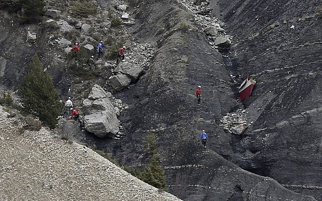 Rescue workers work on debris at the plane crash site near Seyne-les-Alpes, France, Wednesday, March 25, 2015, after a Germanwings jetliner crashed Tuesday in the French Alps. (photo credit: AP/Laurent Cipriani) Rescue workers work on debris at the plane crash site near Seyne-les-Alpes, France, Wednesday, March 25, 2015, after a Germanwings jetliner crashed Tuesday in the French Alps. (photo credit: AP/Laurent Cipriani)
