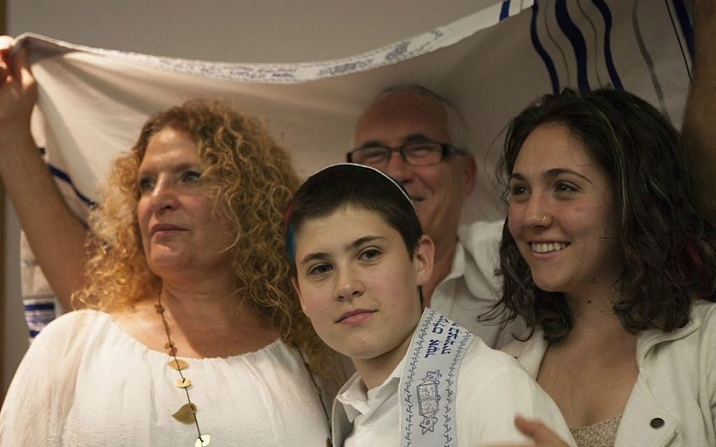 Tom Chai Sosnik with his parents and sister during ceremony at Tehiyah Day School marking his transition from female to male, March 13, 2015.  (Photo credit: Misha Bruk, BrukStudios.com)