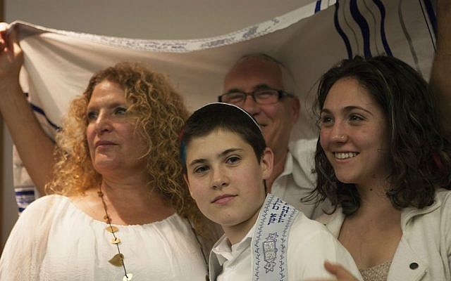 Tom Chai Sosnik with his parents and sister during ceremony at Tehiyah Day School marking his transition from female to male, March 13, 2015.  (Photo credit: Misha Bruk, BrukStudios.com)