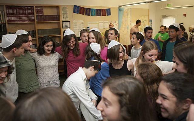 Tom Chai Sosnik's classmates dance with him following ceremony at Tehiyah Day School marking his transition from female to male, March 13, 2015. (photo credit: Misha Bruk, BrukStudios.com)