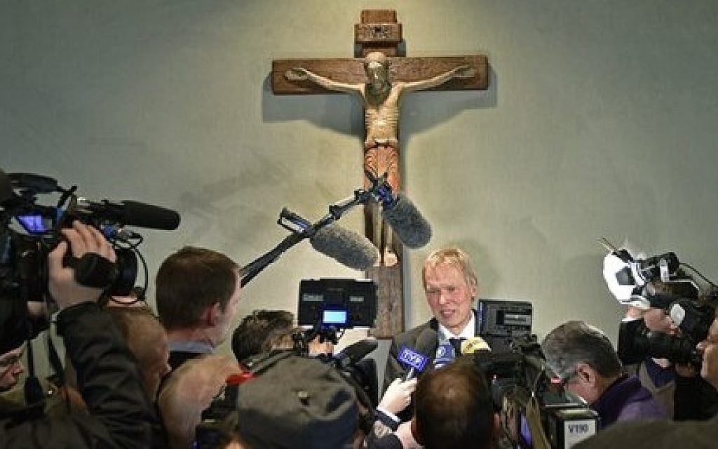 Ulrich Wessel, school principal of the Joseph-Koenig Gymnasium, talks to the media under a crucifix in Haltern, western Germany, Wednesday, March 25, 2015, one day after 16 of his school children and two teachers were among the 150 victims that died in the Germanwings plane crash in the French alps on the way from Barcelona to Duesseldorf. (photo credit: AP Photo/Martin Meissner)