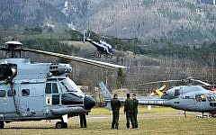 Helicopters of the French Air Force (back) and civil security services are seen in Seyne, south-eastern France, on March 24, 2015, near the site where a Germanwings Airbus A320 crashed in the French Alps.  (photo credit: AFP PHOTO / ANNE-CHRISTINE POUJOULAT