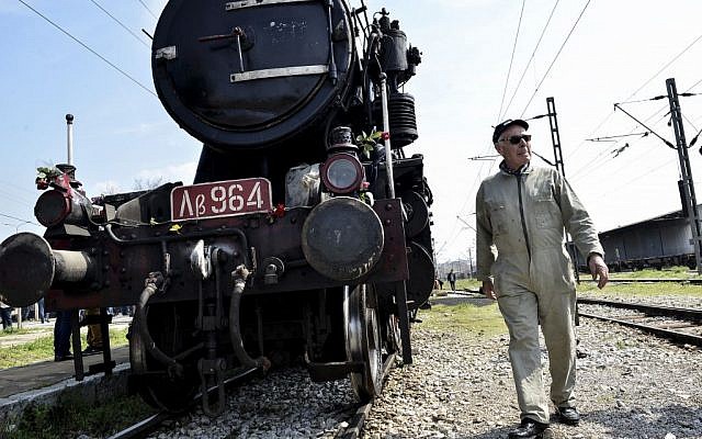 In this Sunday, March 15, 2015 file photo, a Hellenic Railway officer walks in front of a train that was used by the Nazis to carry Jews from Thessaloniki to Auschwitz during the WWII, in the Greek northern town of Thessaloniki, on the 72nd anniversary of the roundup and deportation of its Jews to Nazi extermination camps during World War II. (Photo credit: AP/Giannis Papanikos) In this Sunday, March 15, 2015 file photo, a Hellenic Railway officer walks in front of a train that was used by the Nazis to carry Jews from Thessaloniki to Auschwitz during the WWII, in the Greek northern town of Thessaloniki, on the 72nd anniversary of the roundup and deportation of its Jews to Nazi extermination camps during World War II. (Photo credit: AP/Giannis Papanikos)