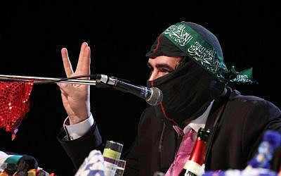 In this Saturday, March 7, 2015 photo Deniz Yucel of German newspaper 'taz' wears a mask during the 'Hate Poetry' show in the Theaterlabor in Bielefeld, Germany. (AP Photo/Oliver Krato)