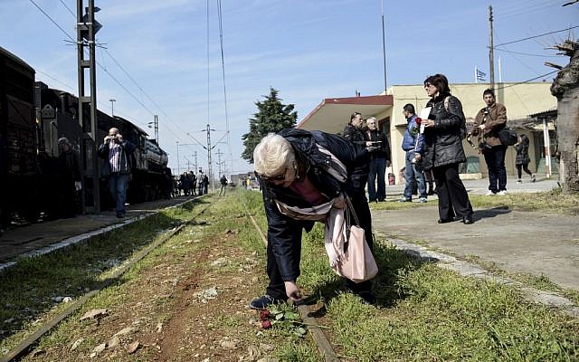 A woman places flowers on a rail at the old train station of the Greek northern town of Thessaloniki, on Sunday, March 15, 2015. Residents of this northern Greek city on Sunday marked the 72nd anniversary of the roundup and deportation of its Jews to Nazi extermination camps during World War II. (AP Photo/Giannis Papanikos) A woman places flowers on a rail at the old train station of the Greek northern town of Thessaloniki, on Sunday, March 15, 2015. Residents of this northern Greek city on Sunday marked the 72nd anniversary of the roundup and deportation of its Jews to Nazi extermination camps during World War II. (AP Photo/Giannis Papanikos)