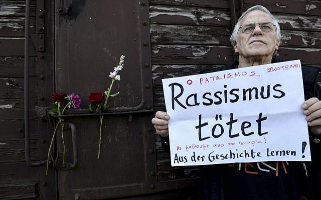 A man holds a banner reading, 'Racism Kills, Let's Learn From the History,' in front of a train wagon that was used by the Nazis to carry Jews from Thessaloniki to Auschwitz during WWII, in the Greek northern town of Thessaloniki, on Sunday, March 15, 2015 (AP Photo/Giannis Papanikos) A man holds a banner reading, 'Racism Kills, Let's Learn From the History,' in front of a train wagon that was used by the Nazis to carry Jews from Thessaloniki to Auschwitz during WWII, in the Greek northern town of Thessaloniki, on Sunday, March 15, 2015 (AP Photo/Giannis Papanikos)