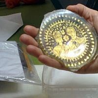 A late Roman gilded glass disk from the Belfer Collection which was used to mark a tomb in the catacombs. (photo credit: Ilan Ben Zion/Times of Israel staff)