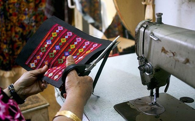 Najla finishes embroydered products in the evening photo credit: Shaina Shealy/Times of Israel Najla finishes embroidered products in the evening (photo credit: Shaina Shealy/Times of Israel