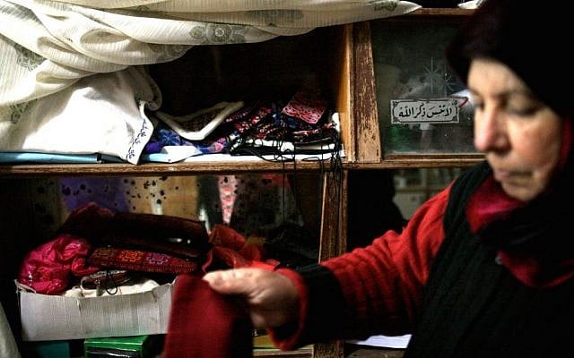 Om Ahmed and her embroidery collection (photo credit: Shaina Shealy/Times of Israel) Om Ahmed and her embroidery collection (photo credit: Shaina Shealy/Times of Israel)