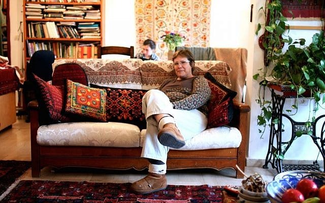 An Israeli woman sits on a sofa with Palestinian stitched cushions in her home in West Jerusalem (photo credit: Shaina Shealy/Times of Israel) An Israeli woman sits on a sofa with Palestinian stitched cushions in her home in West Jerusalem (photo credit: Shaina Shealy/Times of Israel)