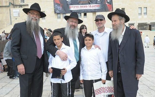 Boys who have been orphaned celebrate their bar mitzva together at the Western Wall in an event organized by Colel Chabad (Photo credit: Kobi Amsalem)