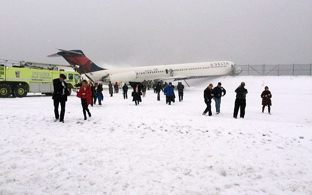 In this photo provided by Amber Reid, a passenger on Delta Flight 1086, passengers leave the plane after the aircraft skidded off the runway while landing at LaGuardia Airport in New York City, March 5, 2015. (photo credit: AP/Amber Reid) In this photo provided by Amber Reid, a passenger on Delta Flight 1086, passengers leave the plane after the aircraft skidded off the runway while landing at LaGuardia Airport in New York City, March 5, 2015. (photo credit: AP/Amber Reid)